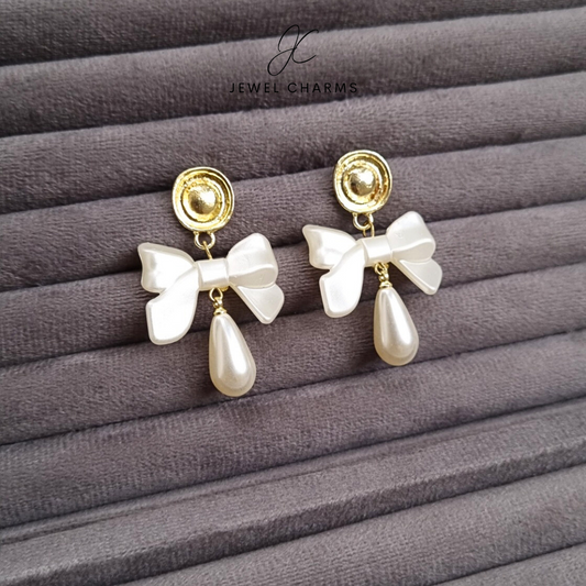 Golden hanging pearl bow earrings