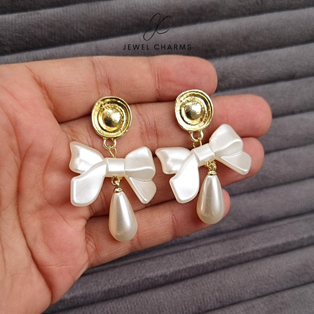 Golden hanging pearl bow earrings